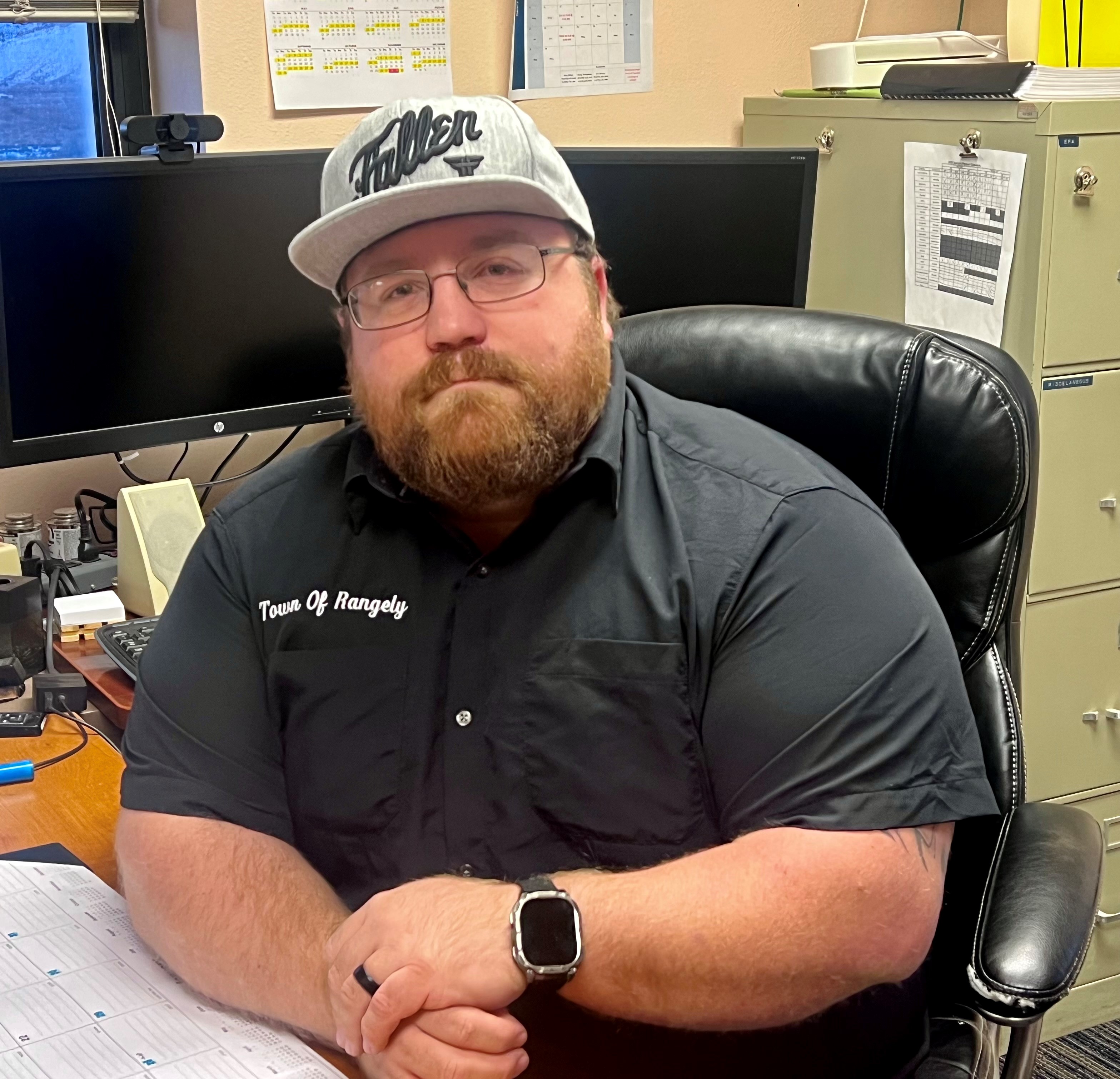 Michael Dillon, Contact, sitting at his desk