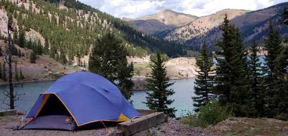 Tent camping near a lake and mountains